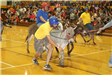 City employees riding and leading donkeys during the donkey ball game
